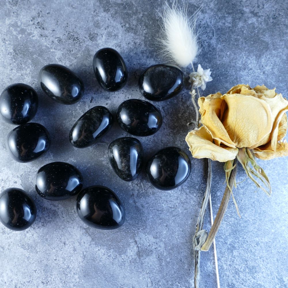 Black Obsidian Tumbled Stones - Dumi's Crystals - Unleash protection and transformation with these smooth, black obsidian stones. Perfect for meditation, crystal healing, or carrying for grounding energy.