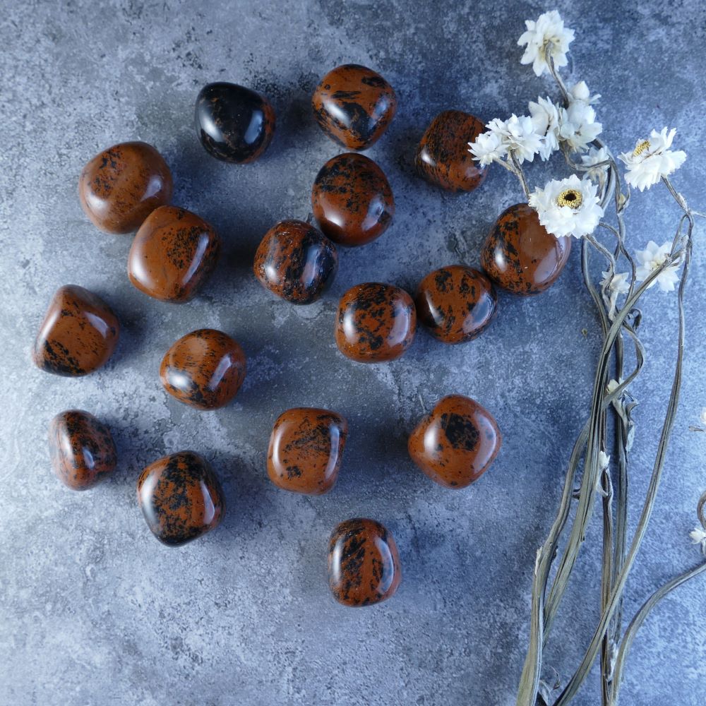 Dumi's Crystals Mahogany Obsidian Tumbles - Grounding & Protection. These deep brown stones (2-2.5cm) promote stability and protection. Ideal for crystal healing practices.