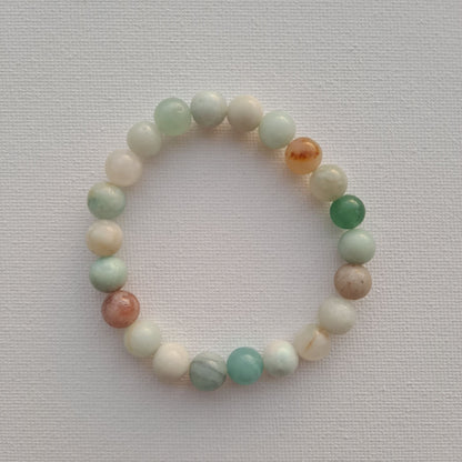 Dumi's Crystals Amazonite Bracelet. This handcrafted bracelet features genuine 8mm Amazonite beads, strung on durable stretch fiber for a comfortable fit. The substantial feel of the larger beads makes it a perfect statement piece. Amazonite is known for its calming energy and grounding properties.