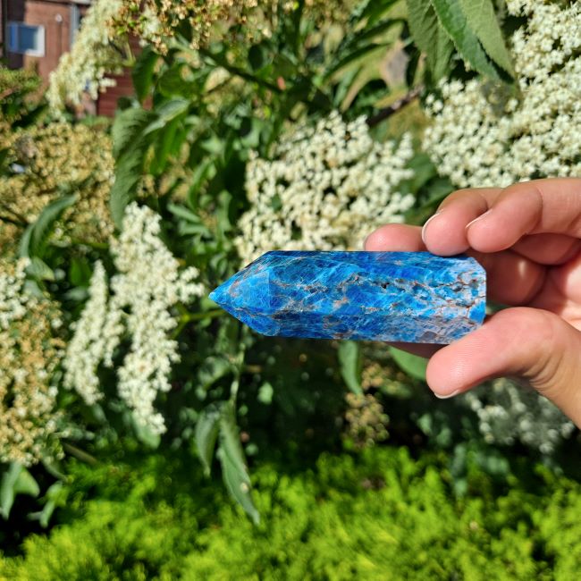 Dumi's Crystals | Blue Apatite Tower (6-10cm) | A close-up view of a captivating Blue Apatite Tower (6-10cm), showcasing its vibrant blue hues and intricate patterns. This crystal is believed to enhance communication, self-expression, and creativity.