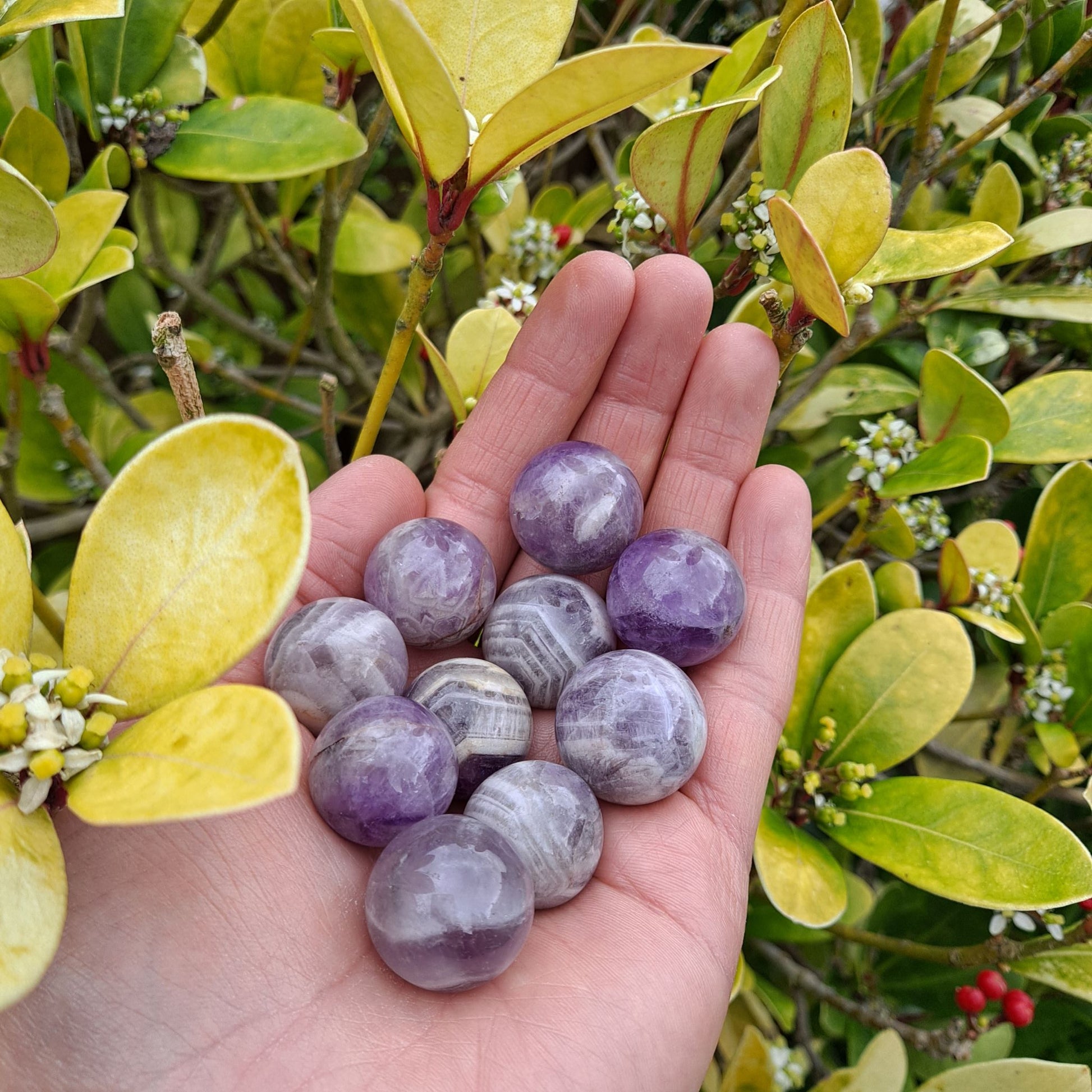 Enhance your crystal collection or create a protected space with Chevron Amethyst mini spheres (20mm) | Dumi's Crystals | Each sphere (20mm) is thought to promote harmony, intuition, and spiritual development, while offering protection from negativity.