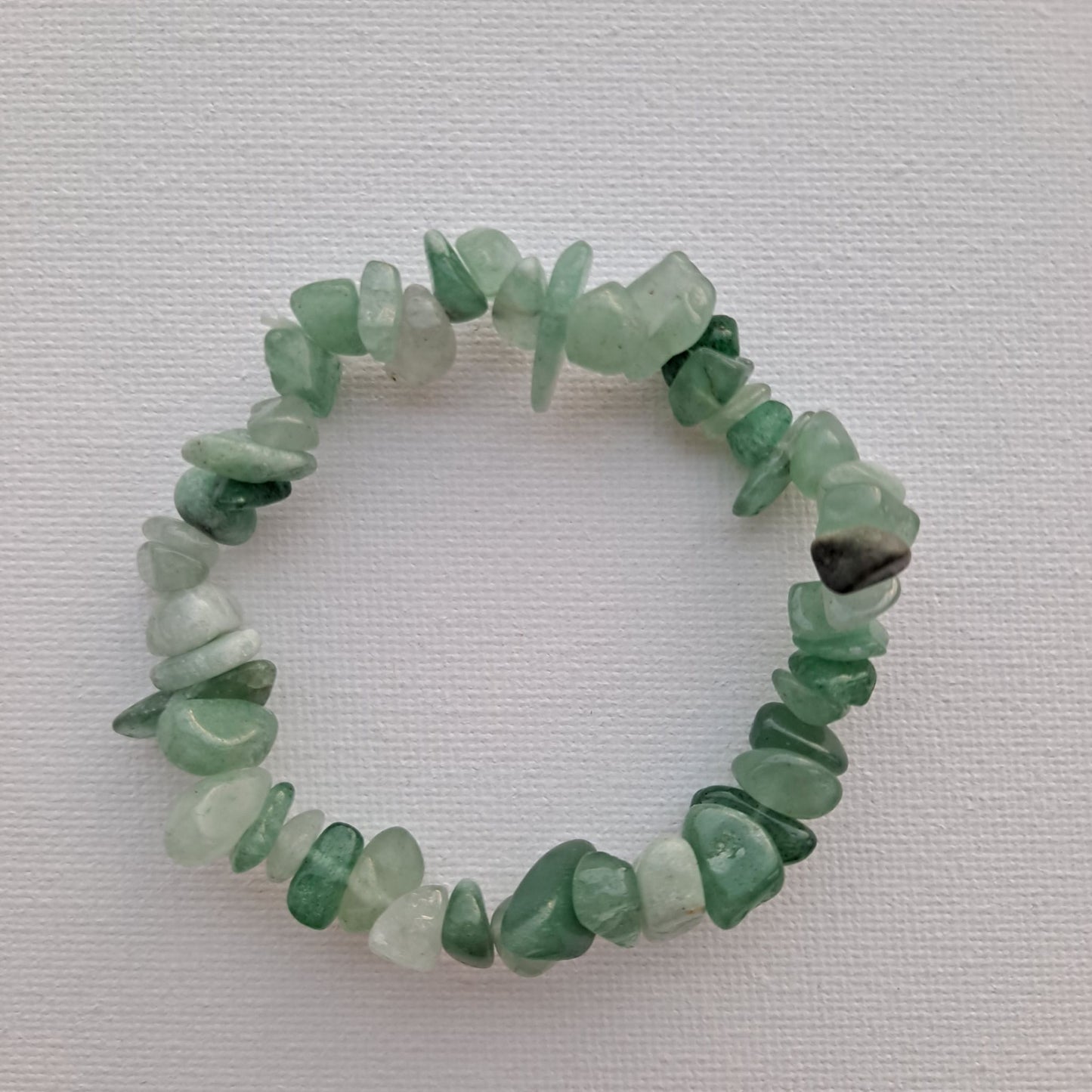 7-Inch Green Aventurine Chip Bracelet | Dumi's Crystals | Delicate Green Aventurine chips cascade beautifully on a durable stretch cord. This bracelet radiates calming energy and offers a touch of casual elegance. Green Aventurine is known for promoting peace, prosperity, and emotional balance.