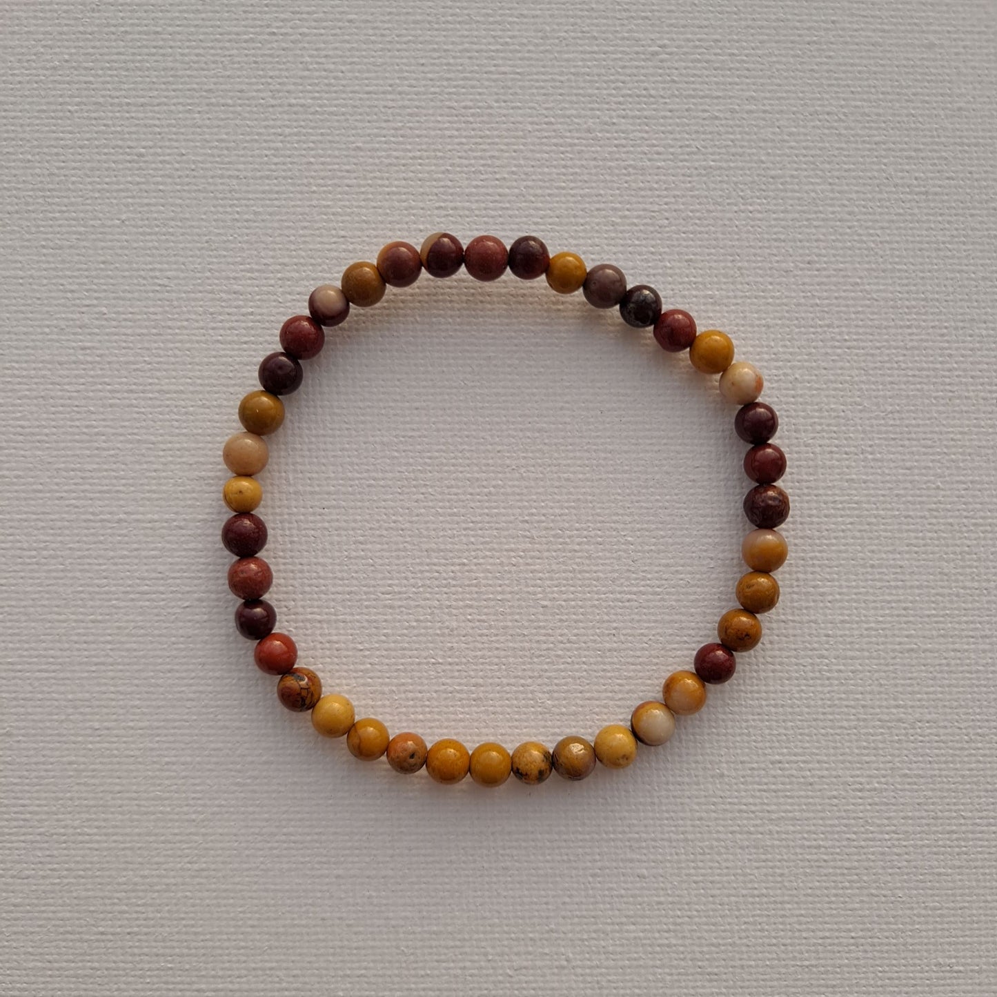 7-Inch Mookaite Jasper Bracelet (4mm Beads) | Dumi's Crystals | Delicate 4mm Mookaite Jasper beads strung on a durable stretch cord. This bracelet is believed to promote emotional balance, stability, and a sense of adventure.