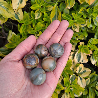 Enhance your crystal collection or create a calming space with Frosted Polychrome Jasper mini spheres (25mm) | Dumi's Crystals | Each sphere (25mm) is thought to promote harmony, relaxation, and a sense of grounding. Invite tranquillity and strength into your life with these beautiful spheres.