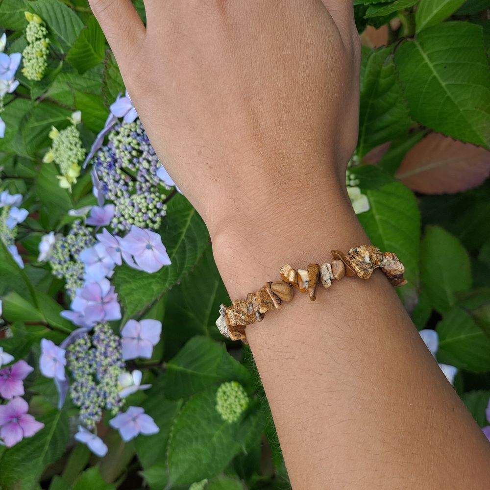 Picture Jasper bracelet on wrist | Dumi's Crystals | This stylish 7-inch stretch bracelet features genuine picture jasper chips, known for their grounding energy and beautiful landscapes.