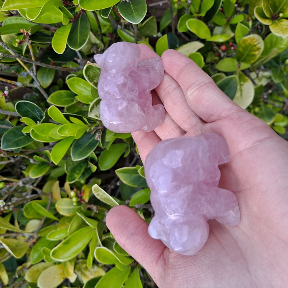 Dumi's Crystals | Rose Quartz Bear Carving (Heart Chakra Harmony):  A close-up of a Rose Quartz Bear Carving, a beacon of love and light. Rose Quartz, the "Stone of Love," promotes positive energy & strengthens relationships. This bear fosters heart chakra harmony. Ethically sourced crystals from Dumi's Crystals.