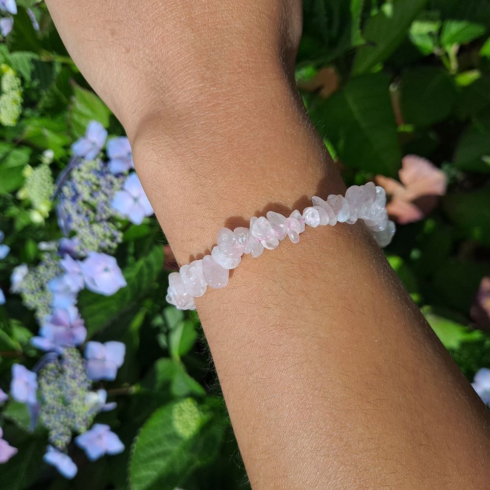 Dumi's Crystals | Rose Quartz Chip Stretch Bracelet (7 Inch) | Showcasing the captivating beauty of Rose Quartz chips on a wrist. This bracelet promotes emotional healing, self-love, and fosters harmony. Rose Quartz, the stone of unconditional love, is known for its delicate pink hues.